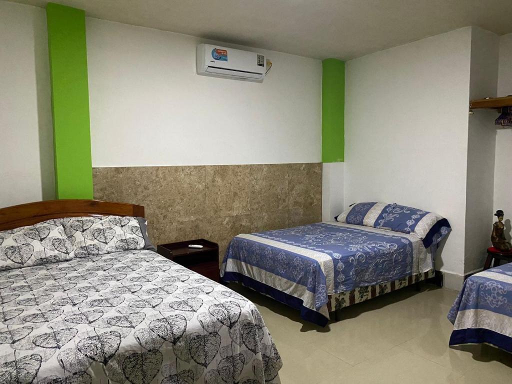 a bedroom with two beds and a air conditioner at Casa en san Cristobal in Puerto Baquerizo Moreno