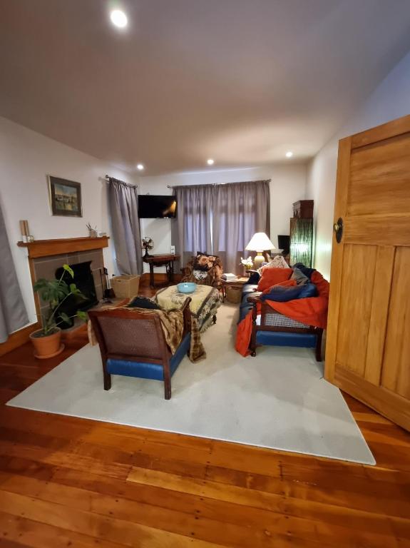 a living room with two chairs and a table at Number 32 in Taumarunui
