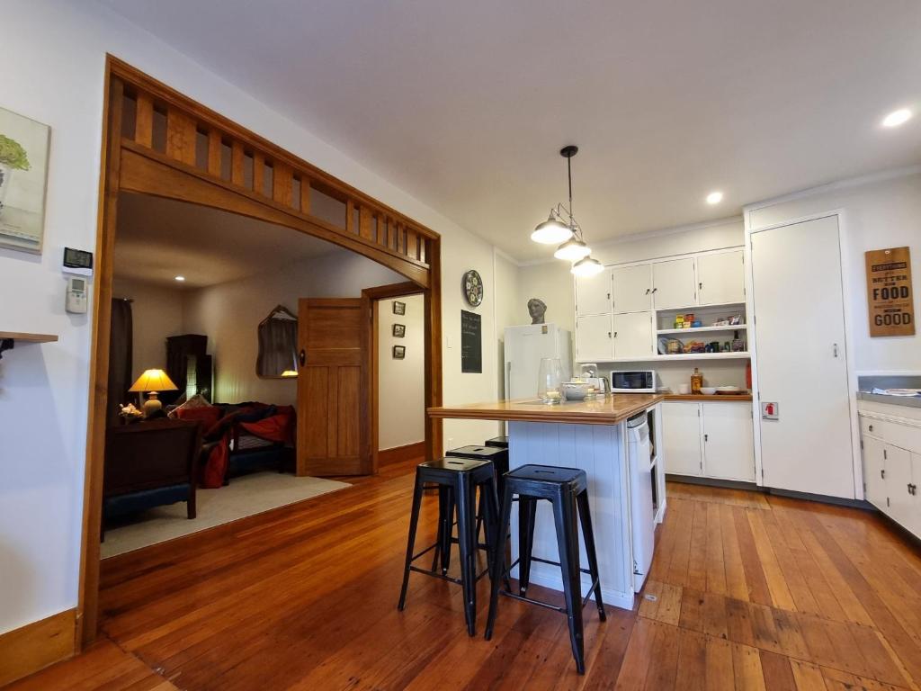 a kitchen with a counter and stools in a room at Number 32 in Taumarunui