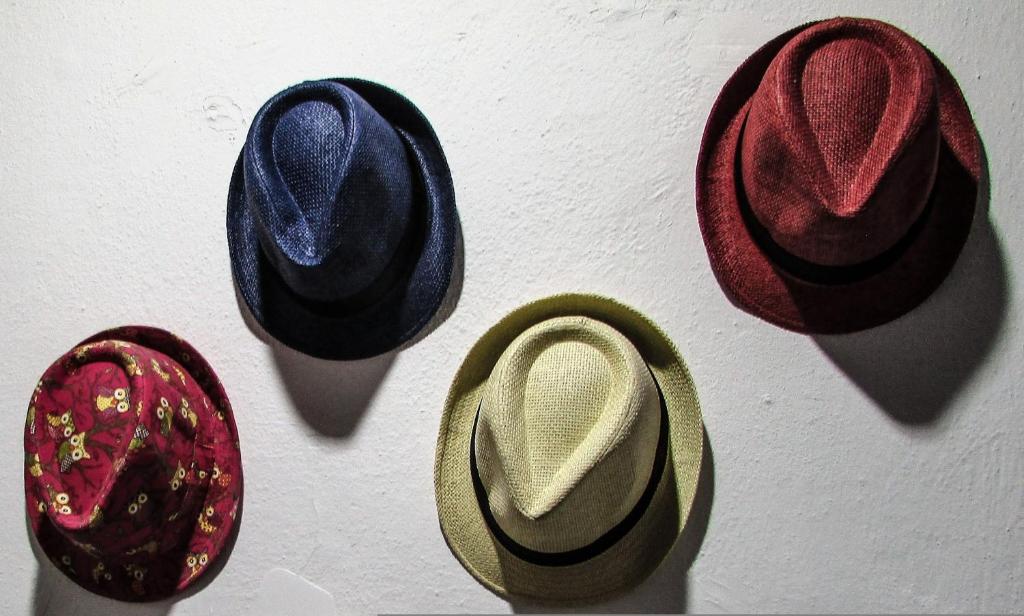 a group of hats hanging on a wall at Depis Place And Apartments Naxos Depis Castle Renata Luxury Apartments-Double Studio in Naxos Chora