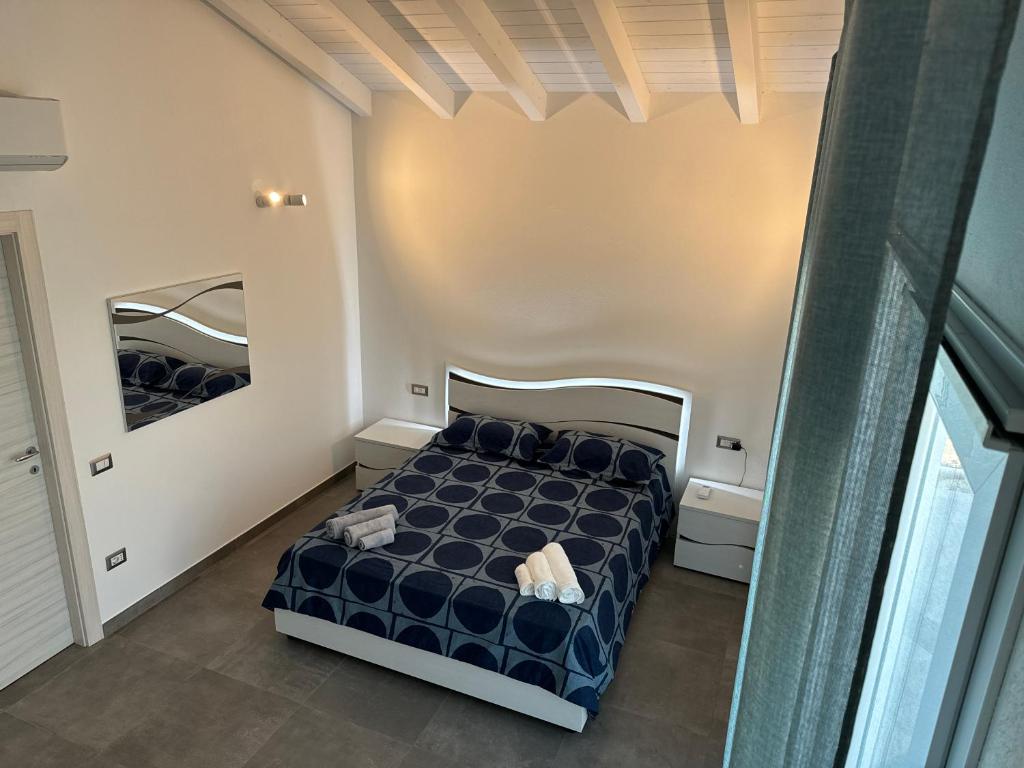 a bedroom with a blue bed in a room at Le Potager in Quartu SantʼElena