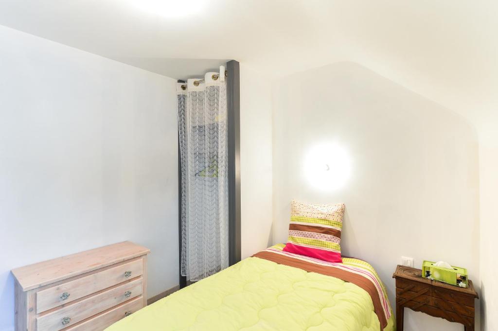 a small bedroom with a bed and a dresser at Domaine de Kervail in Quimperlé