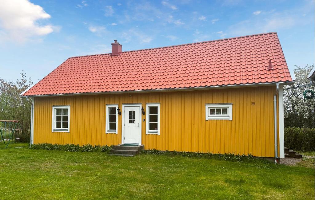mały żółty dom z czerwonym dachem w obiekcie Stunning Home In Frjestaden With Kitchen w mieście Färjestaden