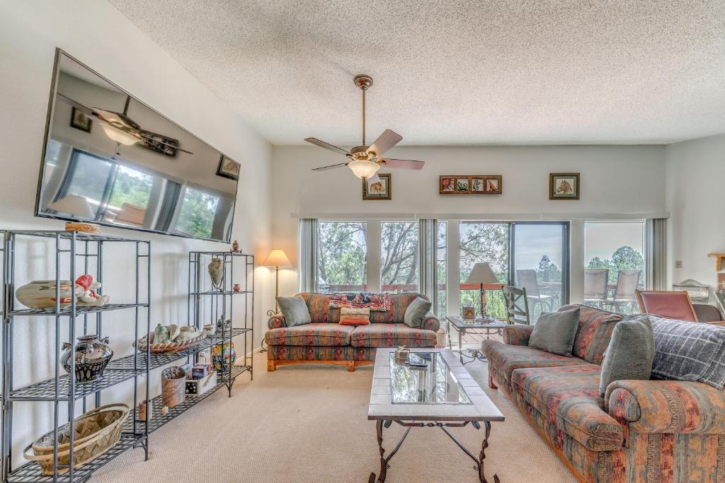 a living room with two couches and a ceiling fan at Alto Townhome with Deck Near Ski Apache! in Alto