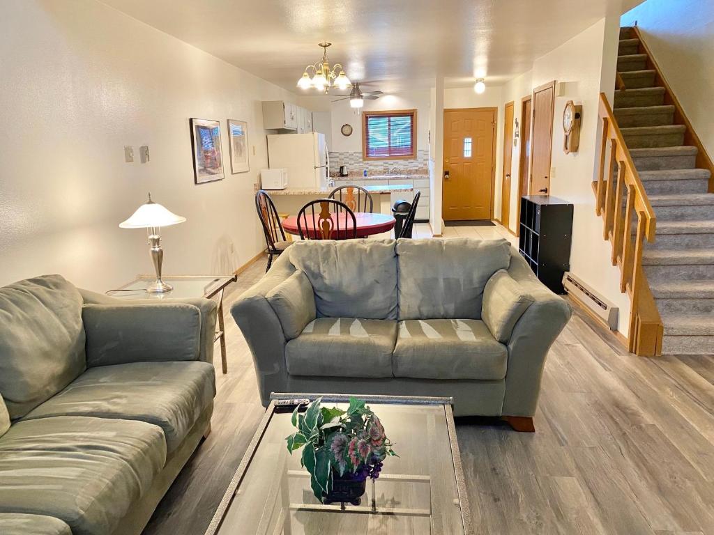 a living room with a couch and a table at Dells Getaway At Tamarack & Mirror Lake Resort in Wisconsin Dells