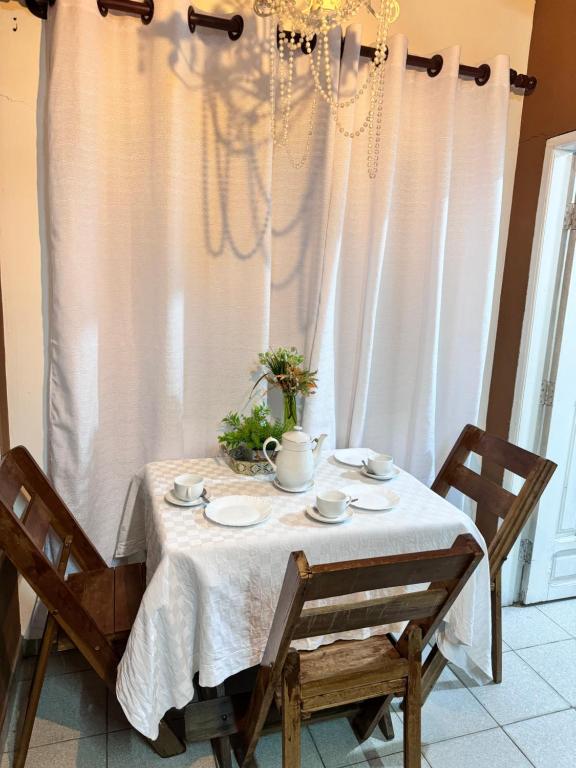 Una mesa de comedor con un mantel blanco y sillas. en Acogedor independiente-Casa JH B, en Santa Cruz de la Sierra