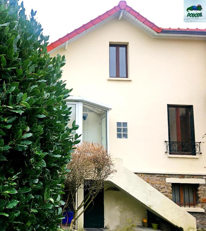 a white house with a staircase in front of it at Ô Cottage La Barre Ormesson - 20 min Paris in Deuil-la-Barre