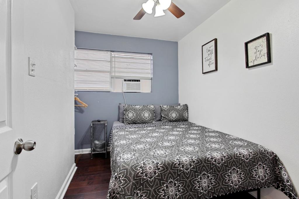 a bedroom with a bed and a ceiling fan at Pao and Pui in Kenner