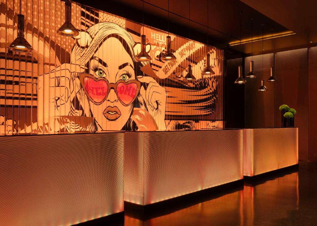 a large painting of a woman with hearts on the wall at art'otel London Hoxton, Powered by Radisson Hotels in London