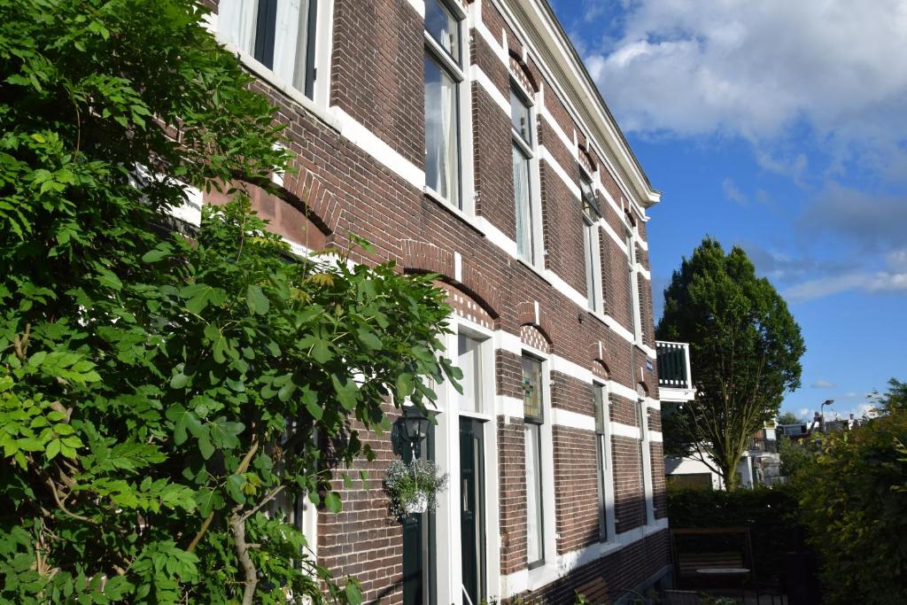 a red brick building with white windows on it at Townhouse Center Arnhem in Arnhem