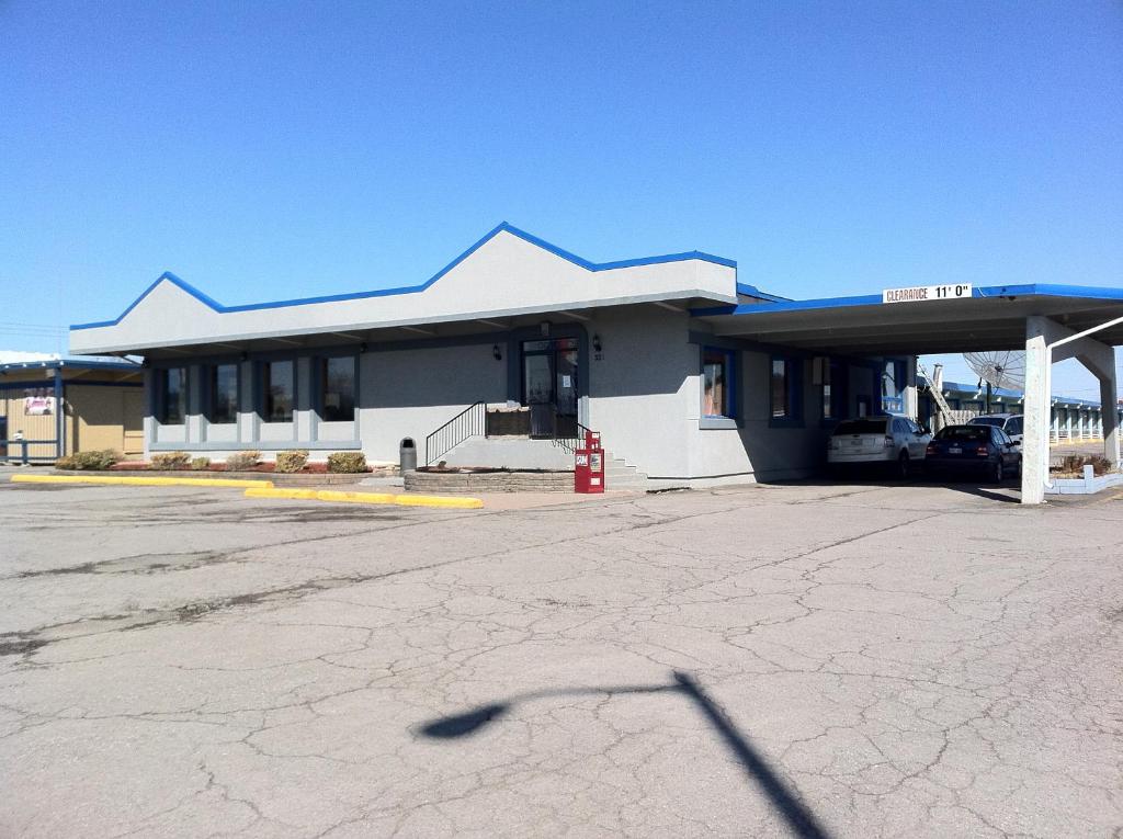 a gas station with a red fire hydrant in front of it at Travelers Inn in Belleville