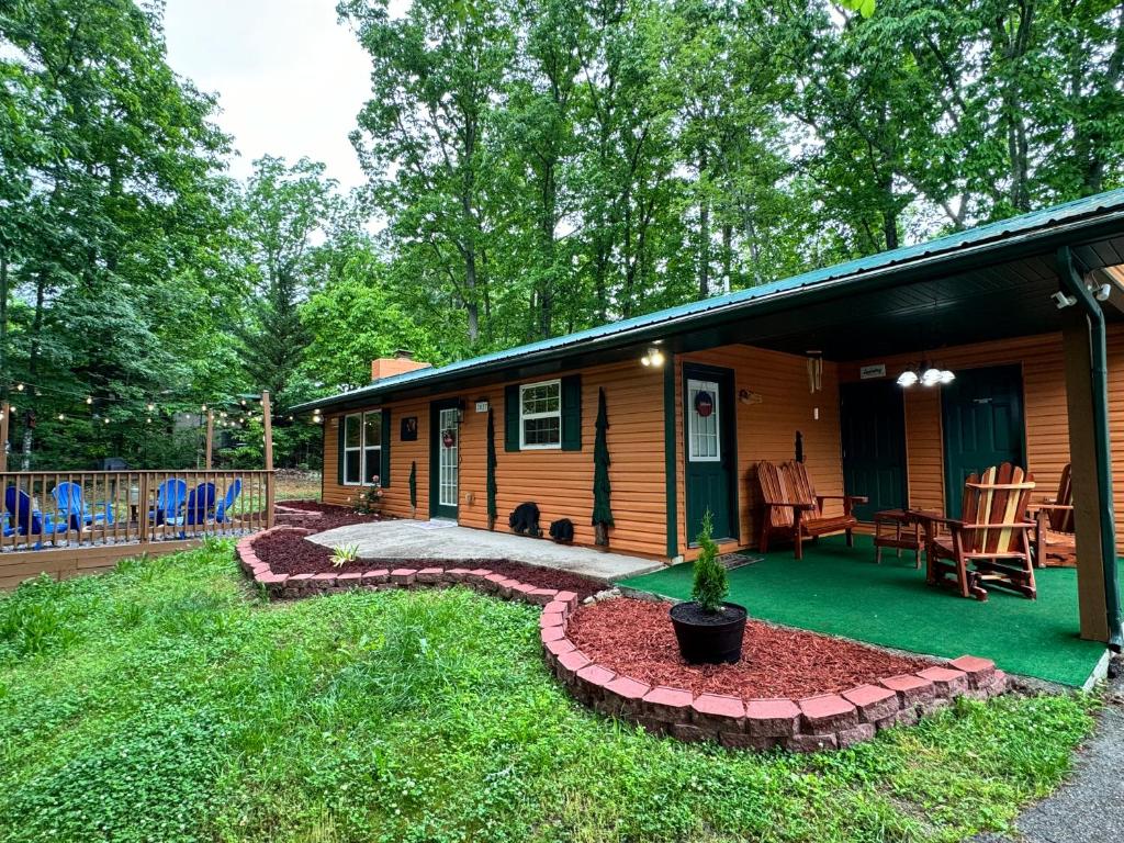 um chalé de madeira com um alpendre e um pátio em Paradise at the Smokies Cabin em Sevierville