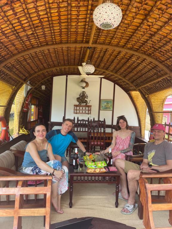 a group of people sitting on a train at Thara's Houseboat in Alleppey