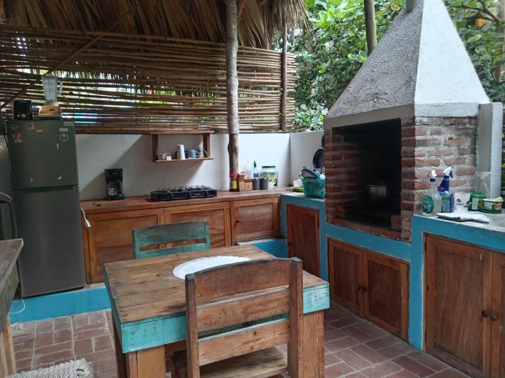 a kitchen with an outdoor kitchen with a brick oven at El Puente in El Paredón Buena Vista