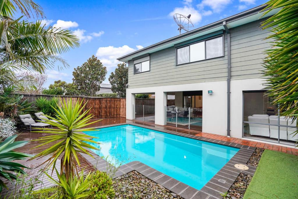 a swimming pool in front of a house at Bundoora Perfection - Luxury Family Oasis with pool in Bundoora