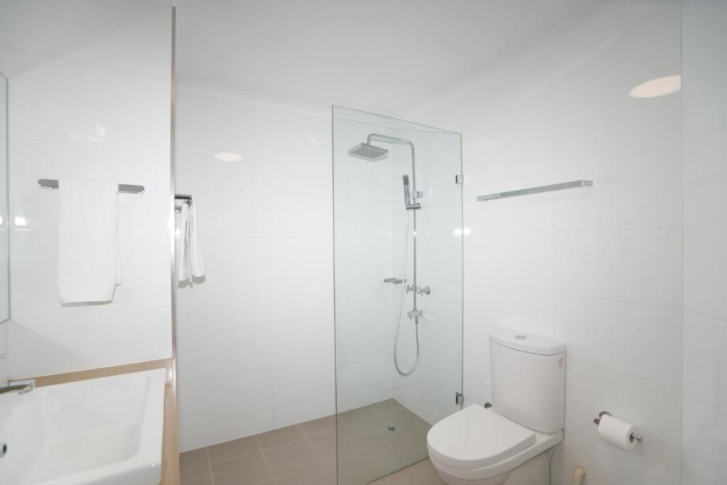 a white bathroom with a shower and a toilet at 2BDR 1BTH 1PRK - James Jem in Perth