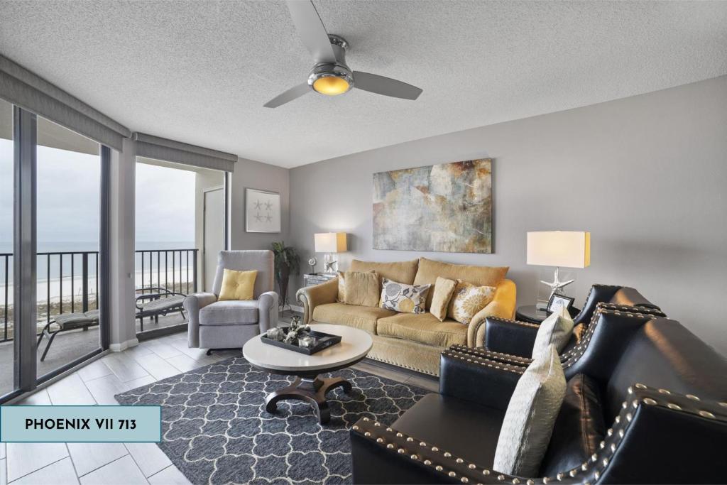 a living room with a couch and a table at Phoenix Vii 713 in Orange Beach