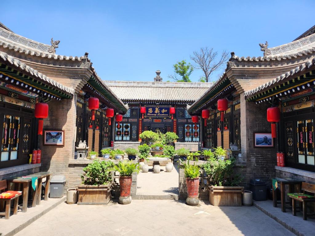 a building with a courtyard with plants in it at Pingyao Harmony Hotel in Pingyao