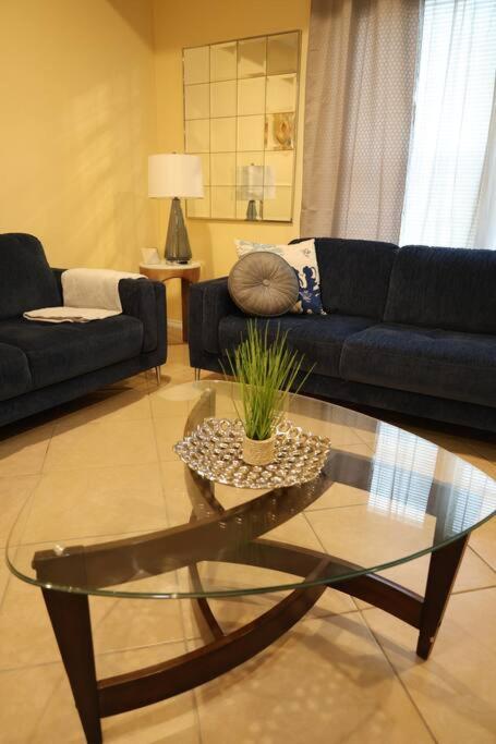 a living room with a couch and a glass table at Mirror, mirror on the wall! in McAllen