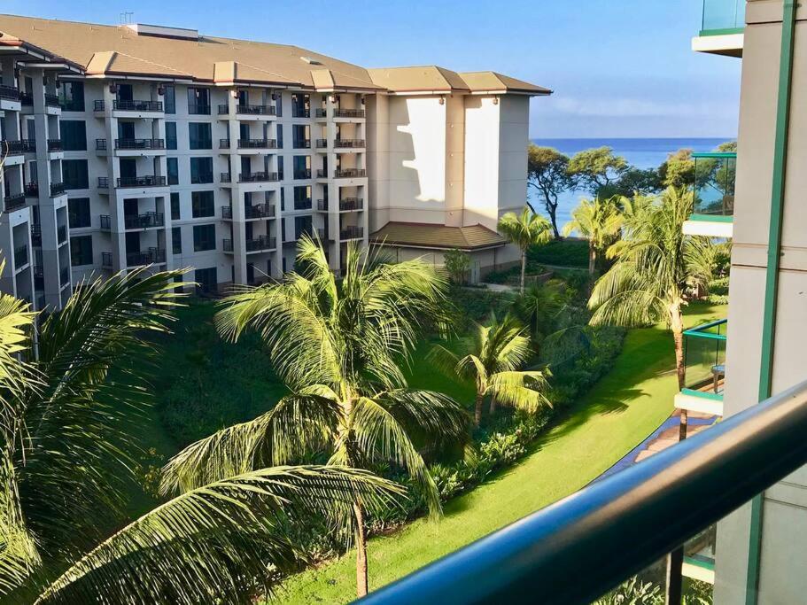 a view from the balcony of a hotel with palm trees at Ocean View One Bedroom at Honua Kai!! in Lahaina