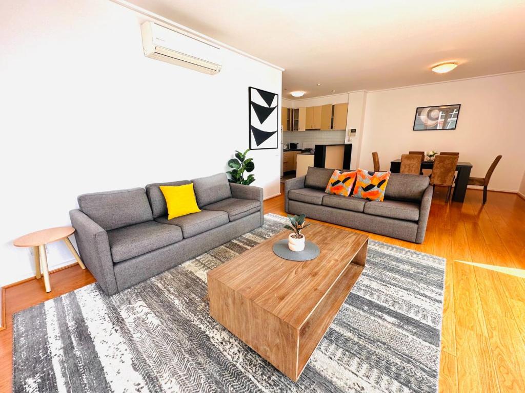a living room with a couch and a coffee table at 3 BR 2 Bath 2 Carparks next to Crown Casino in Melbourne