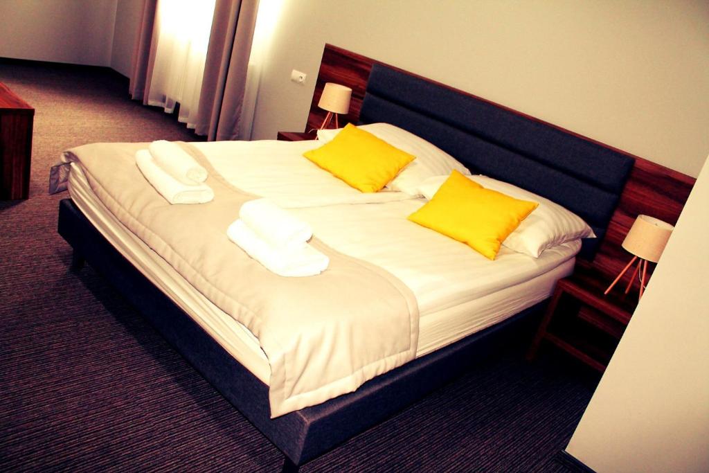 Postel nebo postele na pokoji v ubytování Hotel Klondaik Corner
