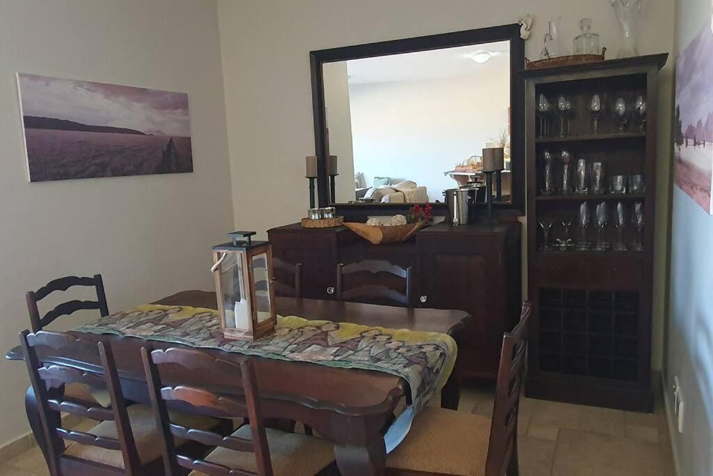 a dining room with a table and a mirror at Sunset View 10 @ Langstrand in Langstrand