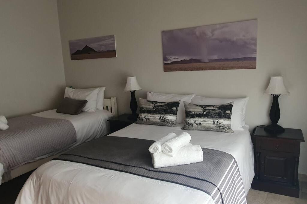 a hotel room with two beds with towels on them at Sunset View 10 @ Langstrand in Langstrand