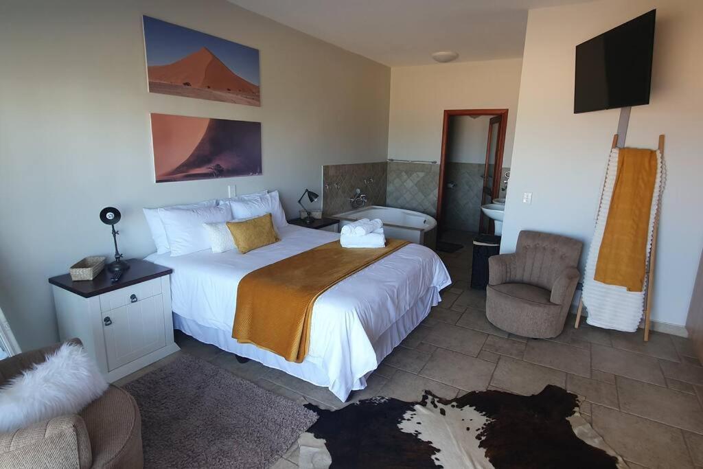 a hotel room with a bed and a bathroom at Sunset View 10 @ Langstrand in Langstrand