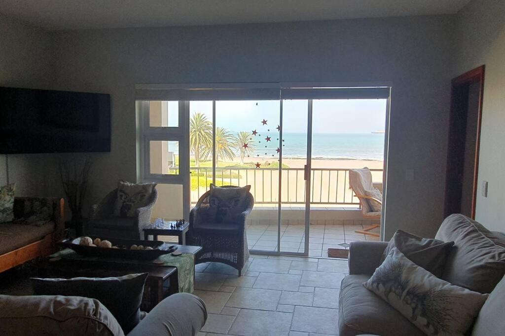 a living room with a view of the beach at Sunset View 10 @ Langstrand in Langstrand