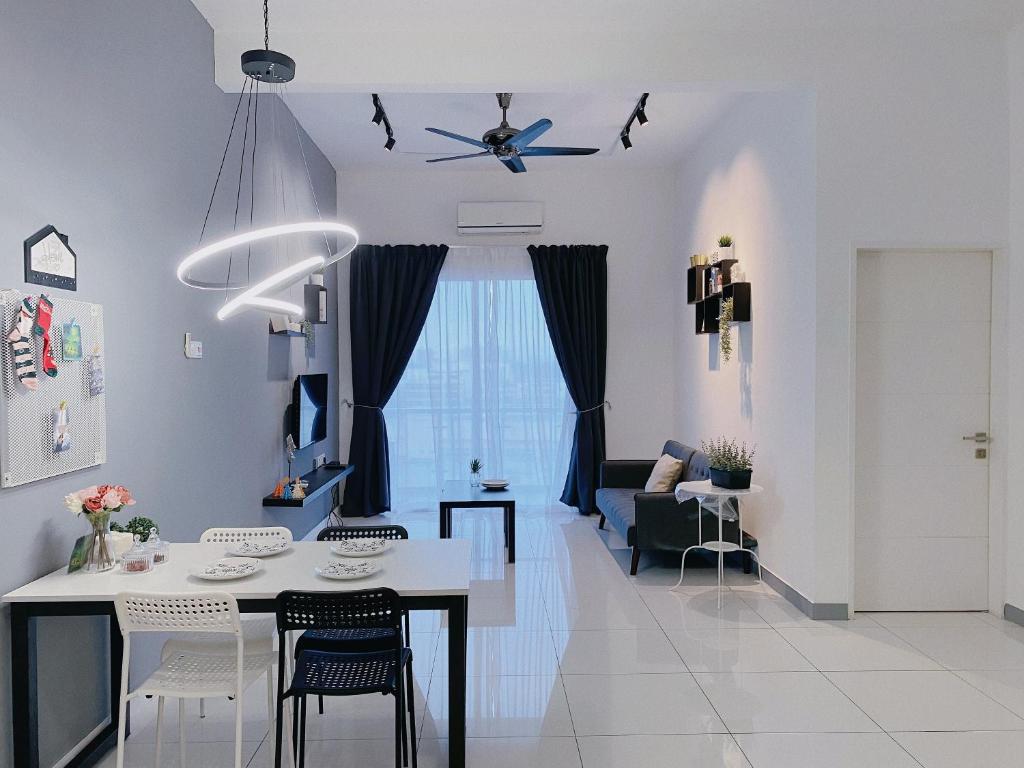 a kitchen and living room with a table and chairs at Beverly Puchong l 100M to IOI Mall in Puchong