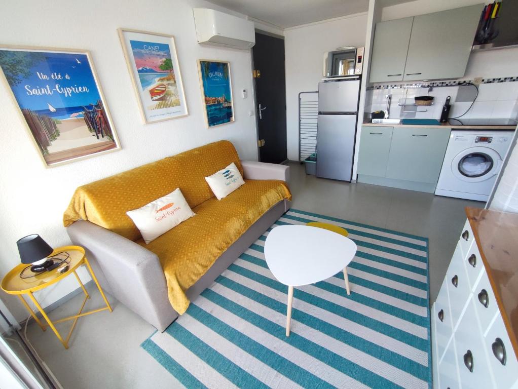 a small living room with a couch and a table at Appartement Plage des Arts in Saint-Cyprien