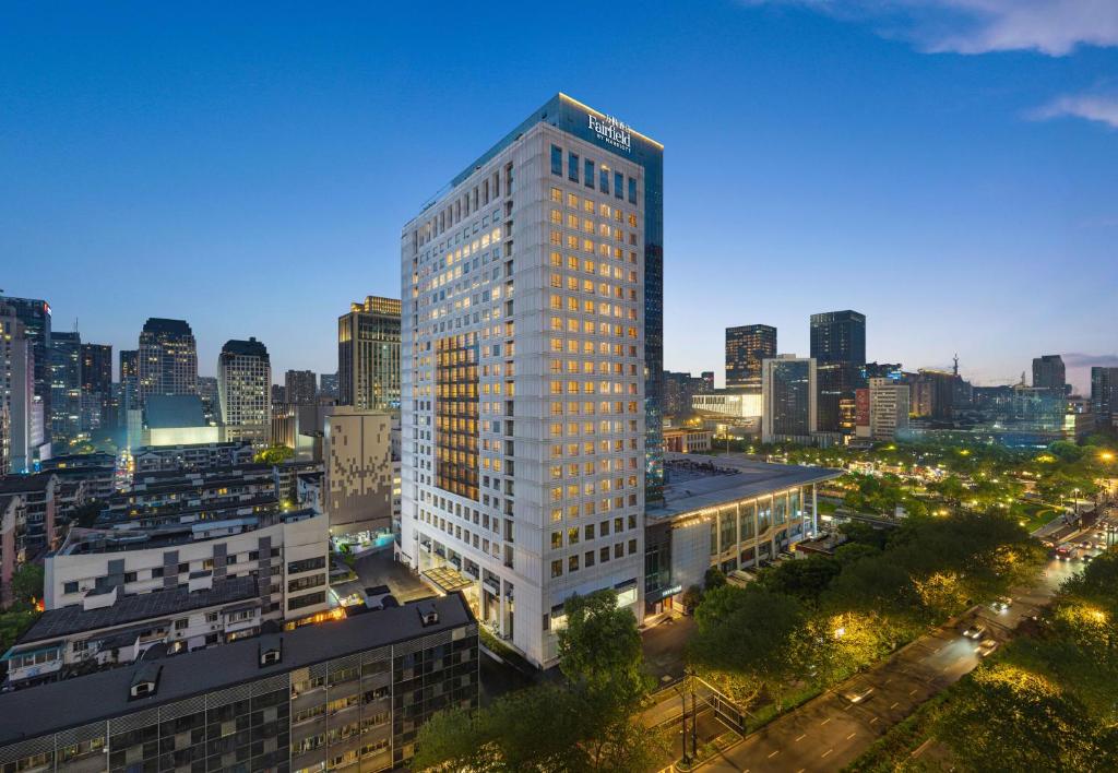 a tall white building in a city at night at Fairfield by Marriott Hangzhou Wulin Square, China in Hangzhou