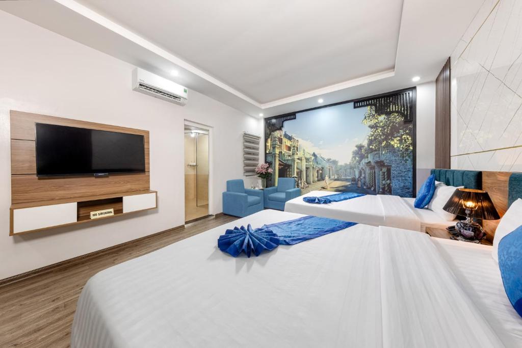 Postel nebo postele na pokoji v ubytování Aquarius Grand Hotel