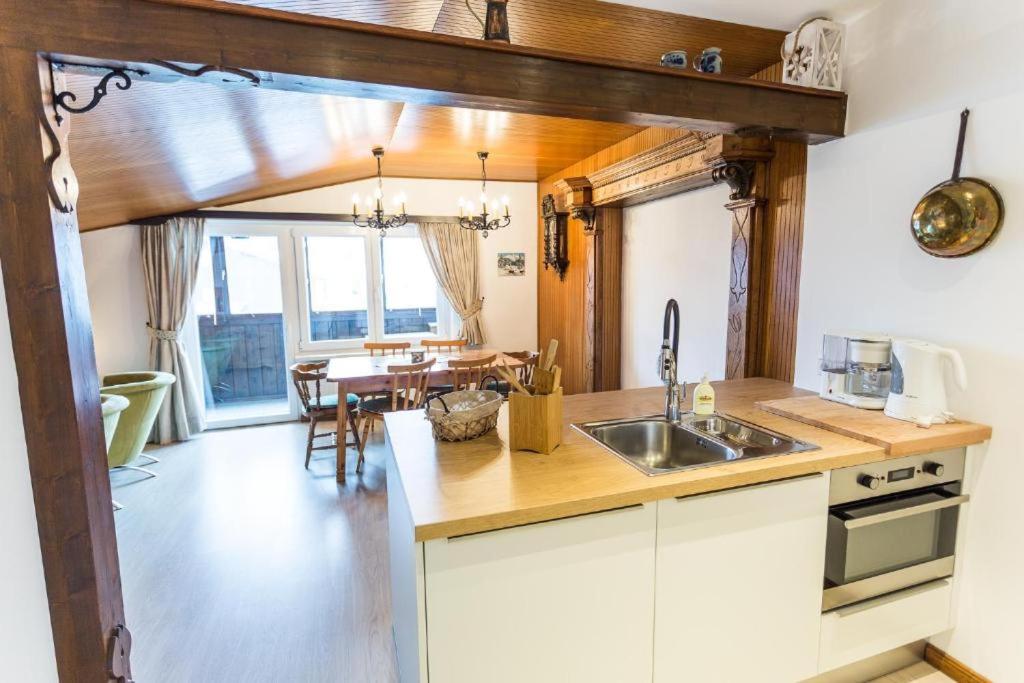 a kitchen with a sink and a table at Appartement Rosimo by MoniCare in Seefeld in Tirol