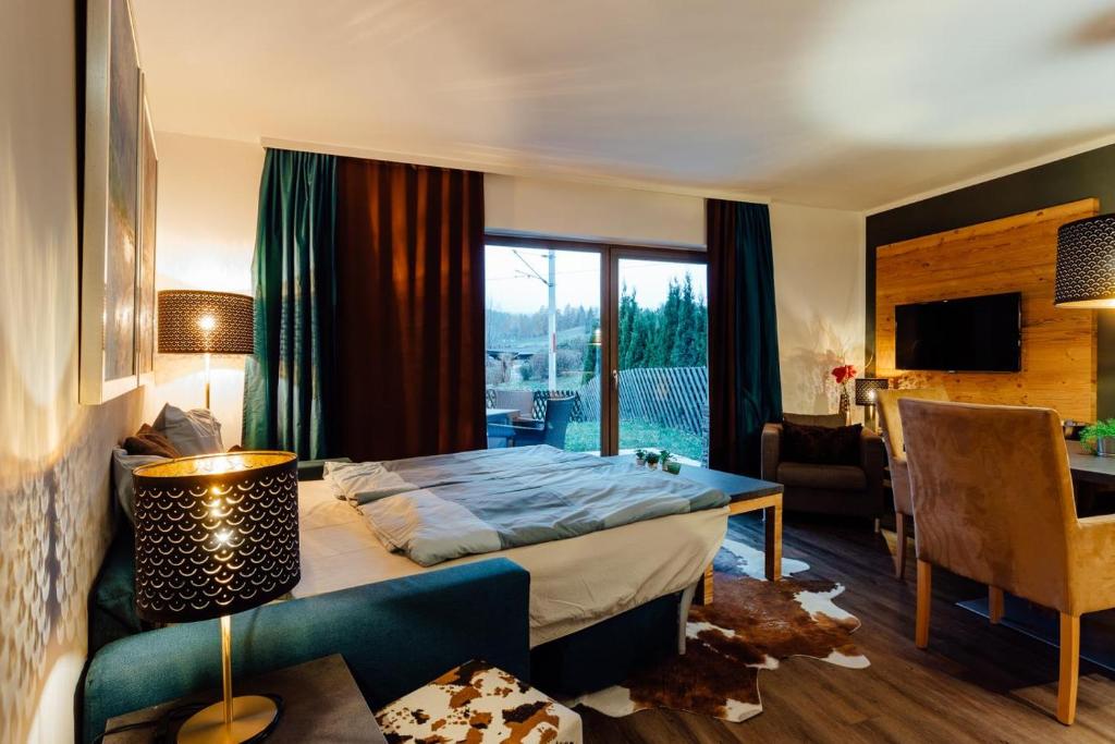 a hotel room with a bed and a living room at Residenz GRETEL by MoniCare in Seefeld in Tirol