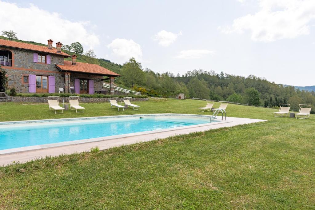 a swimming pool in the yard of a house at Il Serrino 2 in Spignana