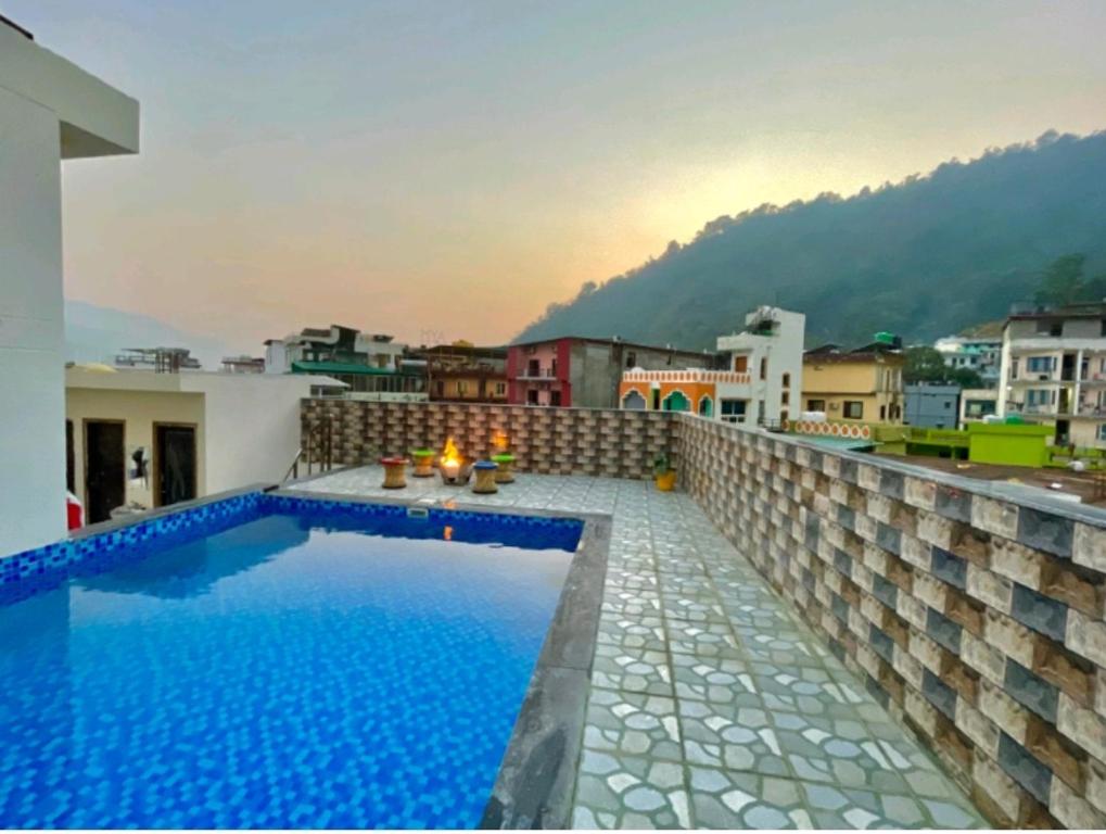 a swimming pool on the roof of a building at Hotel Kedar inn in Rishīkesh