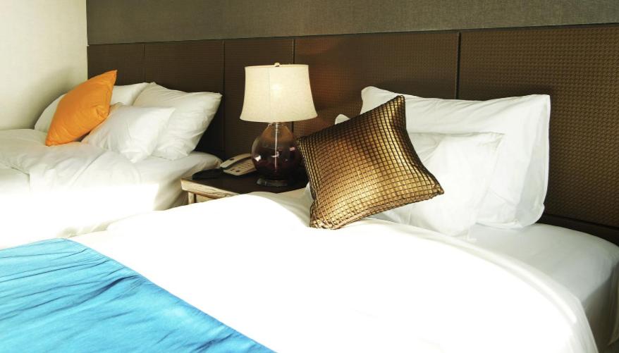 Postel nebo postele na pokoji v ubytování Login Hotel
