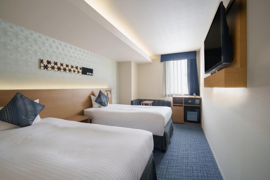 Postel nebo postele na pokoji v ubytování Hotel Vista Nagoya Nishiki
