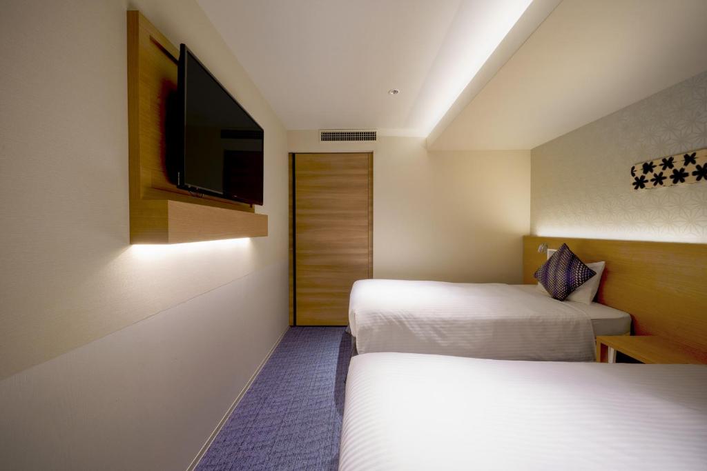 Postel nebo postele na pokoji v ubytování Hotel Vista Nagoya Nishiki