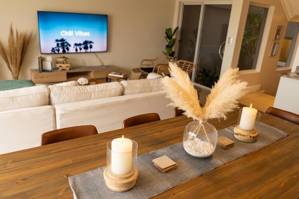 a living room with a table with candles on it at Deja Blue Beachfront Villa in Langstrand