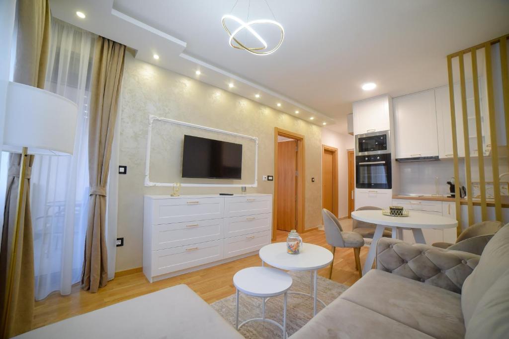 a living room with a couch and a tv at Apartman Divine Lux Zlatibor in Zlatibor