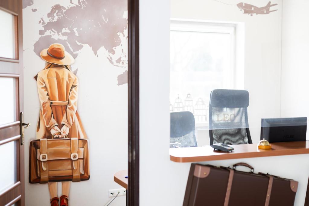 a mannequin with a suitcase in a room at Leo Hostel in Poznań