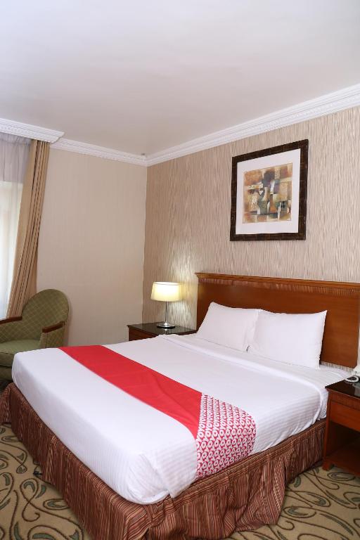 a hotel room with a large bed in a room at City Plaza Hotel in Fujairah