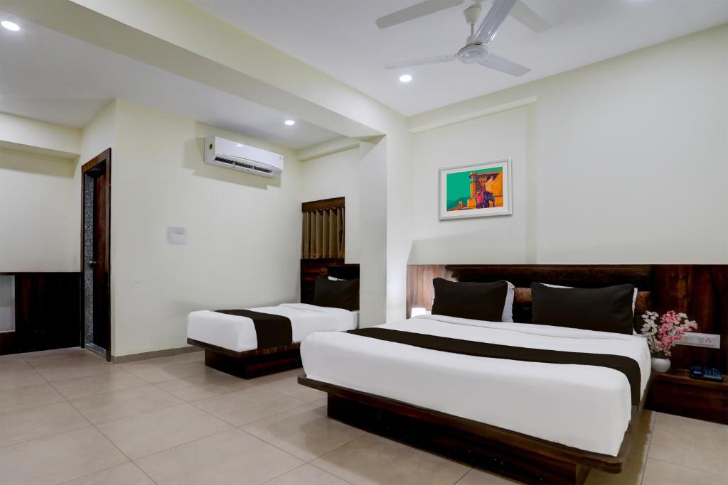 a bedroom with two beds in a room at OYO Hotel HILL PARK I in Vadodara