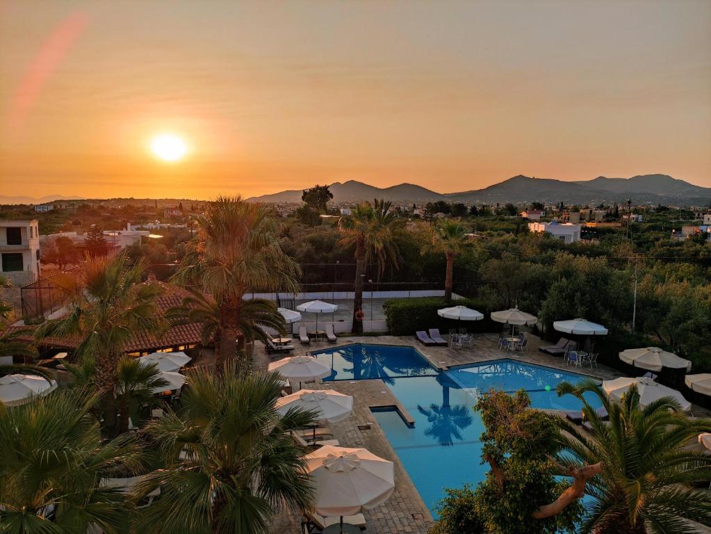 a view of the pool at the resort at sunset at Hotel Klonos - Kyriakos Klonos in Egina