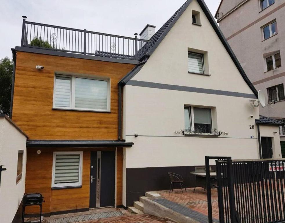 a house with a balcony on top of it at Willa Joanna in Gdańsk