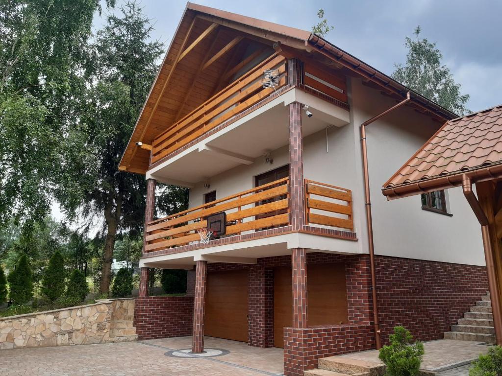 a house with a deck on the side of it at Domek letniskowy Klimkówka 182 in Ropa