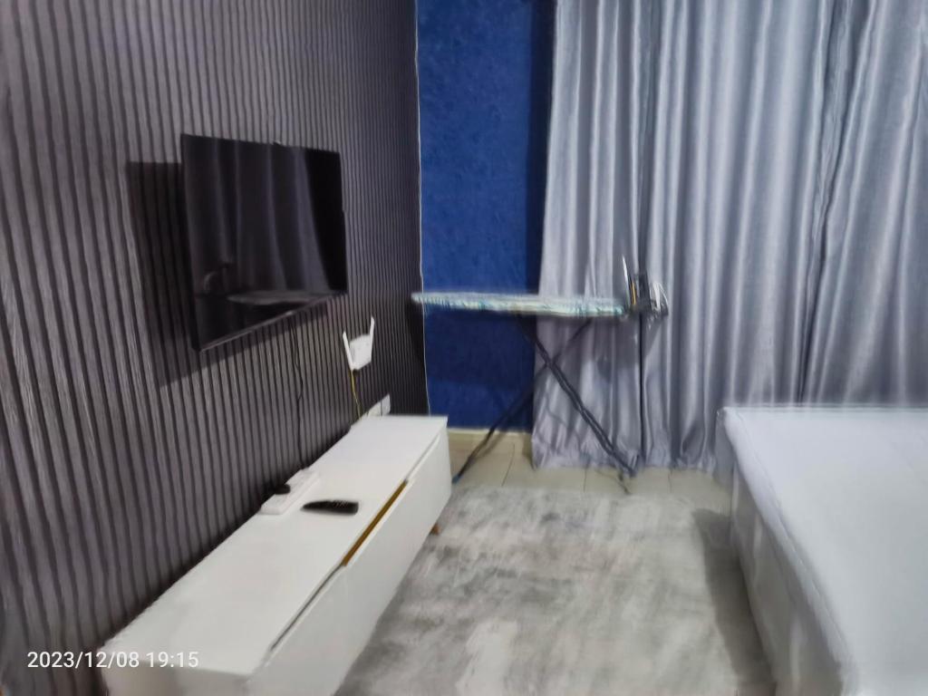 TV a/nebo společenská místnost v ubytování Kigemti Home